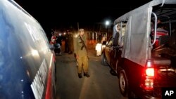 Pakistani police officers cordon off the area of a bomb blast in Raiwind near Lahore, Pakistan, March 14, 2018.