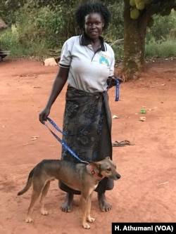 Philda Akum, a former war victim, received her dog Sadiq from the comfort dog project in Pece village, Gulu, Uganda.