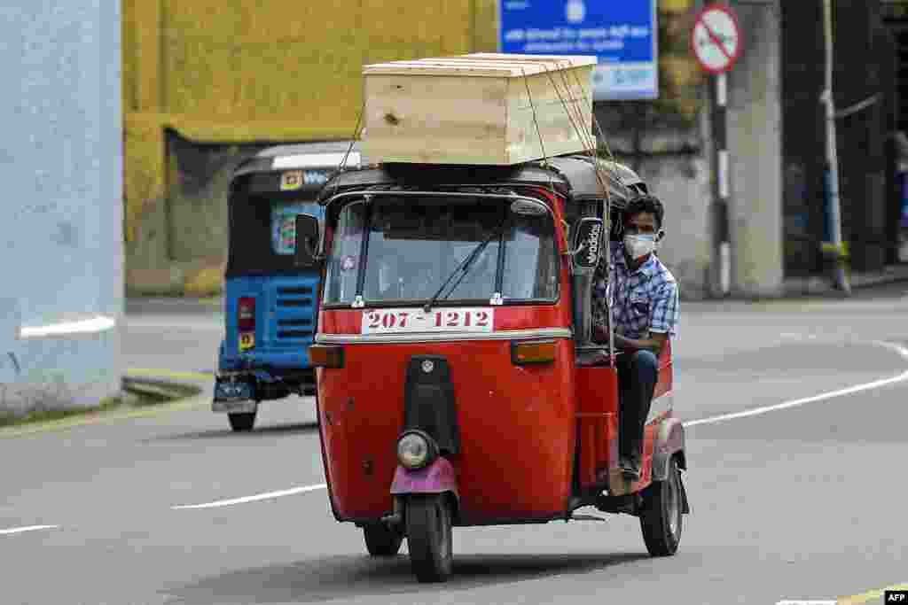 Relatives of a Covid-19 victim transport a coffin on an auto rickshaw to a mortuary in Colombo, Sri Lanka.