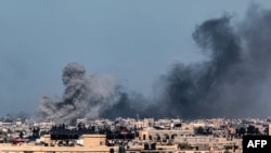 FILE - A picture taken from Rafah shows smoke billowing during Israeli bombardment over Khan Younis in the southern Gaza Strip on February 9, 2024, amid continuing battles between Israel and the Palestinian militant group Hamas. 