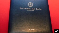 FILE - The President's Daily Briefing "PDB," a top secret leather binder, in which President Bush receives his daily intelligence reports is displayed at the "Spies: Secrets from CIA, KGB, and Hollywood" exhibit at the Ronald Reagan Presidential Library Foundation in Simi Valley, Calif., Feb. 15, 2002. Until the early 1990s, the very existence of the President's daily brief was classified. 