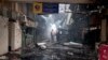 Kenyan airport officials view the damage after a fire engulfed the international arrivals area of Jomo Kenyatta International Airport, in Nairobi, Kenya, on Aug. 7, 2013.