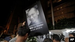 Protesters mourn jailed Chinese Nobel Peace laureate Liu Xiaobo during a demonstration outside the Chinese liaison office in Hong Kong, July 13, 2017.