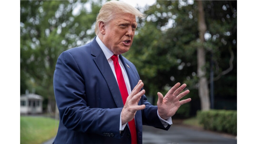 FILE - President Donald Trump speaks with reporters on the South Lawn of the White House, July 31, 2020.