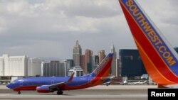 FILE - Southwest Airlines aircraft are seen in front of the Las Vegas strip in Nevada. Technological problems Wednesday have posed lingering problems.