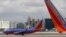 FILE - Southwest Airlines aircraft are seen in front of the Las Vegas strip in Nevada. Technological problems Wednesday have posed lingering problems.