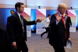 Aide John McEntee directs President Donald Trump as he participates in the U.S.-ASEAN Summit in Manila, Philippines Nov. 13, 2017.