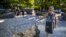 A visitor touches one of the granite slabs at the 9/11 Memorial Glade at the National September 11 Memorial & Museum in New York, Aug. 29, 2019. 