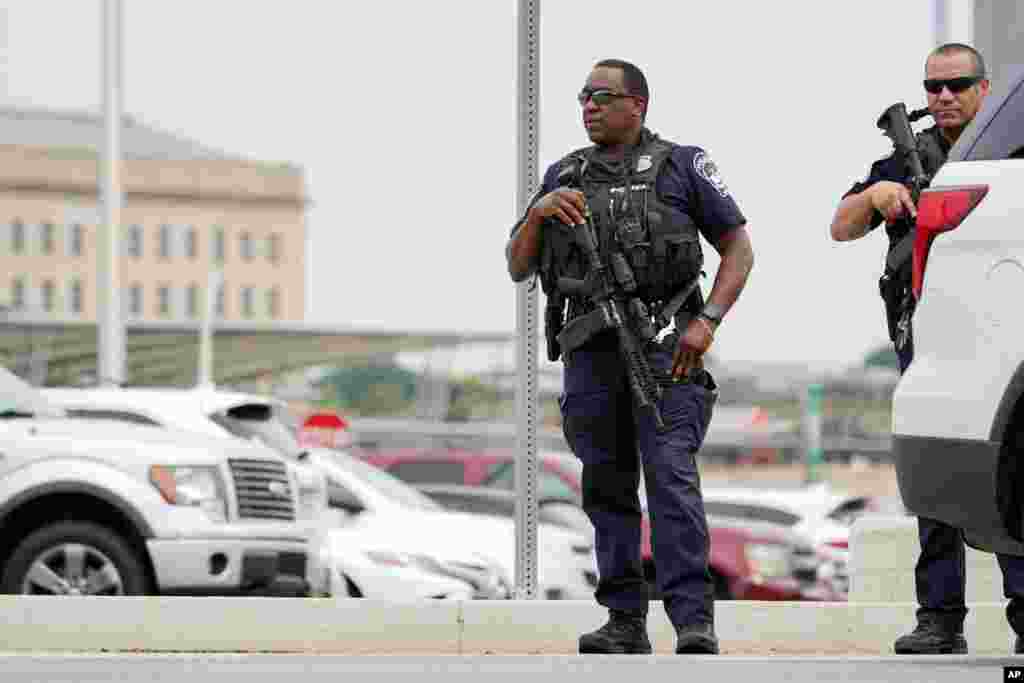 Police officers are seen outside the Pentagon Metro area at the Pentagon in Washington. Gunshots were fired near the entrance of the Pentagon, resulting in multiple injuries.