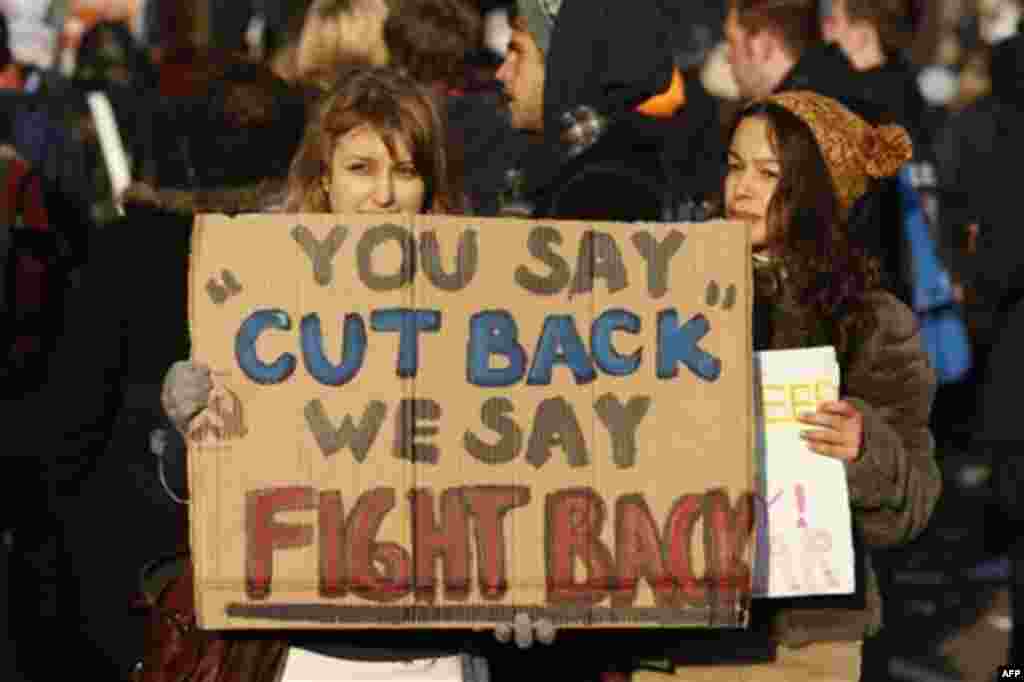 A protester displays her message as thousands of student protest against tuition fees at Whitehall in London, Wednesday, Nov. 24, 2010. Thousands of British students protested Wednesday against government plans to triple tuition fees, two weeks after a si