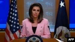 FILE - U.S. State Department spokeswoman Morgan Ortagus stands at the lectern during a press conference at the State Department, in Washington, June 10, 2019. 