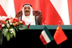 FILE - Kuwait's Emir Sheikh Sabah al-Ahmad al-Jaber al-Sabah looks as he witnesses a signing ceremony with Chinese President Xi Jinping at the Great Hall of the People in Beijing.