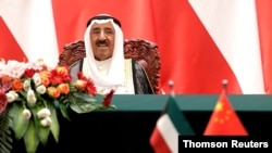 FILE - Kuwait's Emir Sheikh Sabah al-Ahmad al-Jaber al-Sabah looks as he witnesses a signing ceremony with Chinese President Xi Jinping at the Great Hall of the People in Beijing, China, July 9, 2018. 