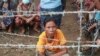 Family members and friends wait to welcome released prisoners outside the Insein Prison, Oct. 19, 2021, in Yangon, Myanmar.