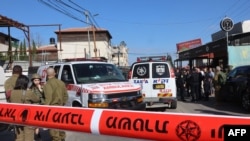 FILE - Israeli rescuers and security forces work at the site of an attack near the village of al-Funduq, in the occupied West Bank, on Jan. 6, 2025.