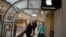 FILE - customers walk at an Apple Premium reseller inside the Moscow GUM State Department store in Moscow, Russia, Nov. 28, 2014.