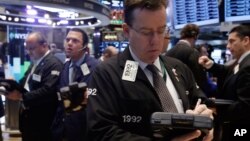 Traders work on the floor of the New York Stock Exchange, Nov. 18, 2013.