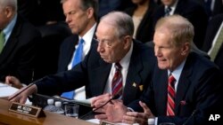 Sen. Bill Nelson, D-Fla., right, accompanied by Sen. John Thune, R-S.D., left, and Sen. Chuck Grassley, R-Iowa, second from left, before a joint hearing of the Commerce and Judiciary committees on Capitol Hill, April 10, 2018.