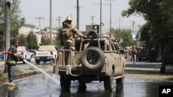 Afghan security personnel leave the scene of a roadside bomb explosion in Kabul, Afghanistan., June 6, 2021, as the U.S. withdrawal from Afghanistan is more than half done.