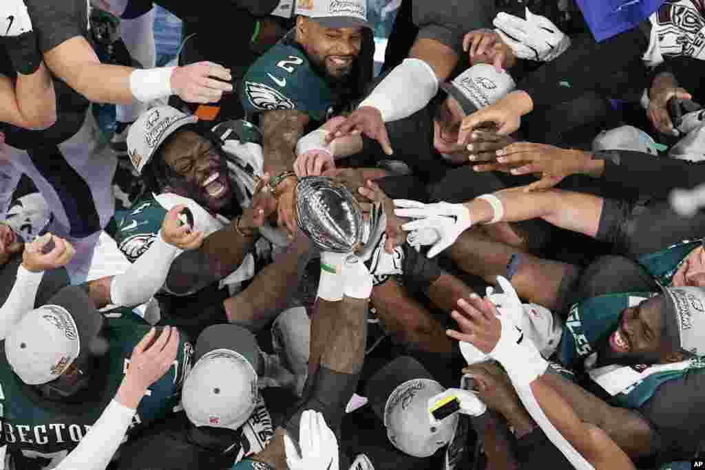 Philadelphia Eagles players celebrate with the Vince Lombardi Trophy after the Eagles won the NFL Super Bowl 59 football game against the Kansas City Chiefs, Feb. 9, 2025, in New Orleans.