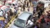 Police officers inspect a car after unidentified gunmen carried out an attack on a prominent Pakistani cleric in Karachi, Pakistan, March 22, 2019.