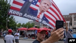 A supporter of U.S. President Donald Trump takes a selfie near the BOK Center in Tulsa, Oklahoma, June 19, 2020.