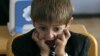 A first grader attends his first English language lesson at a local school in Tbilisi, September 15, 2010.