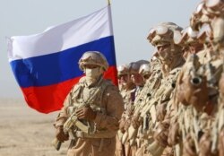 FILE - Russian servicemen participate in joint military drills involving Russia, Uzbekistan and Tajikistan, at the Harb-Maidon training ground, located near the Tajik-Afghan border in the Khatlon region of Tajikistan, August 10, 2021.