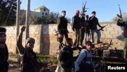 Free Syrian Army fighters cheer after saying they seized the al-Yadoudeh government checkpoint in al-Yadoudeh area in Deraa March 24, 2013.