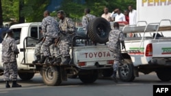 FILE - Burundi policemen patrol the street following a grenade attack in Bujumbura, Burundi. Among the groups not invited to the Arusha talks is the National Council for the Restoration of the Arusha Accord, also known as CNARED.