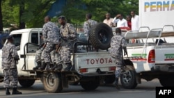 Burundi policemen patrol the street following a grenade attack in Bujumbura, Burundi. At least a dozen people were wounded Feb. 15 when attackers on a motorbike hurled three grenades n the capital.