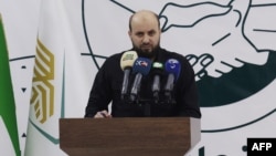 FILE - Mohammed al-Bashir holds a press conference in the rebel-held northwestern Syrian city of Idlib on Nov. 28, 2024.