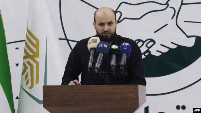 FILE - Mohammed al-Bashir holds a press conference in the rebel-held northwestern Syrian city of Idlib on Nov. 28, 2024.