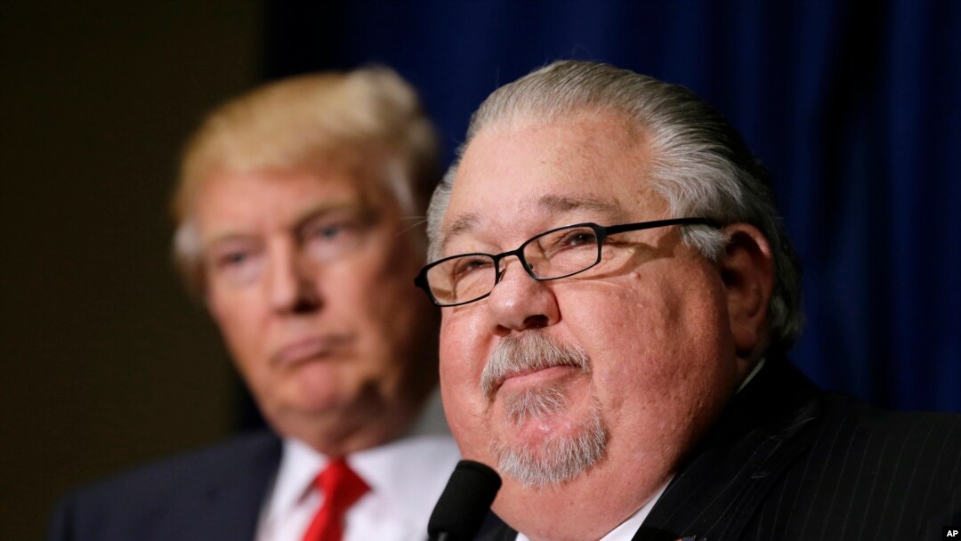 FILE - Sam Clovis speaks during a news conference as then-Republican presidential candidate Donald Trump, left, watches before a campaign rally in Dubuque, Iowa, Aug. 25, 2016. 