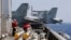FILE - U.S. Navy crewmen from the U.S. Navy aircraft carrier USS Carl Vinson (CVN 70) prepare to load missiles to F-18 fighter jets prior to a routine patrol off the disputed South China Sea Friday, March 3, 2017. Philippines South China Sea-US Military