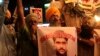 FILE - Indian Sikhs shout slogans against Pakistan as they display photographs of Sarabjit Singh, a convicted Indian spy who was on Pakistan's death row, in Kolkata, India, May 2, 2013. Singh died after he was attacked with a brick in a Lahore jail in 2013.