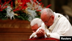 Pope Francis leads the Christmas Eve Mass in Saint Peter's Basilica at the Vatican, Dec. 24, 2017. 