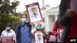 Members of National Nurses United protest in front of the White House, in Washington, April 21, 2020. The protest was to draw attention to healthcare workers who have been infected with COVID-19 from a lack of personal protective equipment.