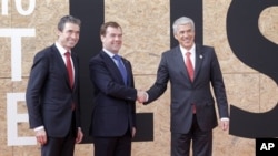 From left, NATO Secretary General Anders Fogh Rasmussen, Russian President Dmitry Medvedev and Portuguese Prime Minister Jose Socrates are seen prior to participating in a NATO Russia Council meeting at a NATO summit in Lisbon, 20 Nov 2010