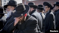 Mourners attend the funeral for seven children killed in a Brooklyn fire in New York, March 22, 2015. 