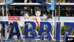 FILE - A bus is parked in Tabriz's Clock Tower Square in Tabriz, April 25, 2018. Ten people in the area have died from tainted alcohol, the state-run news agency reported. 