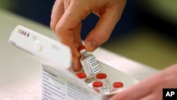 Doses of the COVID-19 vaccine developed by Oxford University and U.K.-based drugmaker AstraZeneca are checked as they arrive at the Princess Royal Hospital in Haywards Heath, England, Saturday Jan. 2, 2021. 