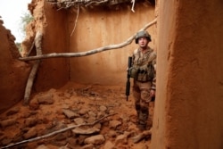 A French soldier of the 2nd Foreign Engineer Regiment inspects a damaged house during an area control operation in the Gourma region during Operation Barkhane in Ndaki, Mali, July 28, 2019.