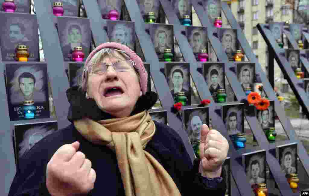 An elderly woman cries at the memorial for the killed Maidan activists during a ceremony marking the third anniversary of the Euromaidan beginning in central Kyiv, Ukraine.