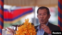 FILE: Cambodia's Prime Minister Hun Sen speaks during a groundbreaking ceremony of the Project for Flood Protection, donated by Japan, in Phnom Penh, Cambodia, March 4, 2019. REUTERS