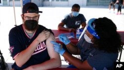 A man receives a Johnson & Johnson vaccine at a COVID-19 vaccination clinic hosted by the Washington Nationals outside of Nationals Park In Washington, D.C., before a baseball game against the Colorado Rockies, Sept. 18, 2021.