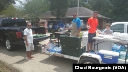 At least one crew of volunteers has been traveling around St. Amant on a trailer with coolers full of food and a working grill, delivering fresh meals.