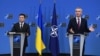 FILE - Ukrainian President Volodymyr Zelenskiy, left, and NATO Secretary General Jens Stoltenberg are seen during a press conference after their bilateral meeting at European Union headquarters in Brussels, Belgium, Dec. 16, 2021. 