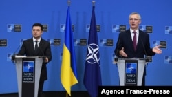 FILE - Ukrainian President Volodymyr Zelenskiy, left, and NATO Secretary General Jens Stoltenberg are seen during a press conference after their bilateral meeting at European Union headquarters in Brussels, Belgium, Dec. 16, 2021. 