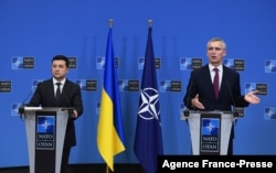 FILE - Ukrainian President Volodymyr Zelenskiy, left, and NATO Secretary General Jens Stoltenberg are seen during a press conference after their bilateral meeting at European Union headquarters in Brussels, Belgium, Dec. 16, 2021.